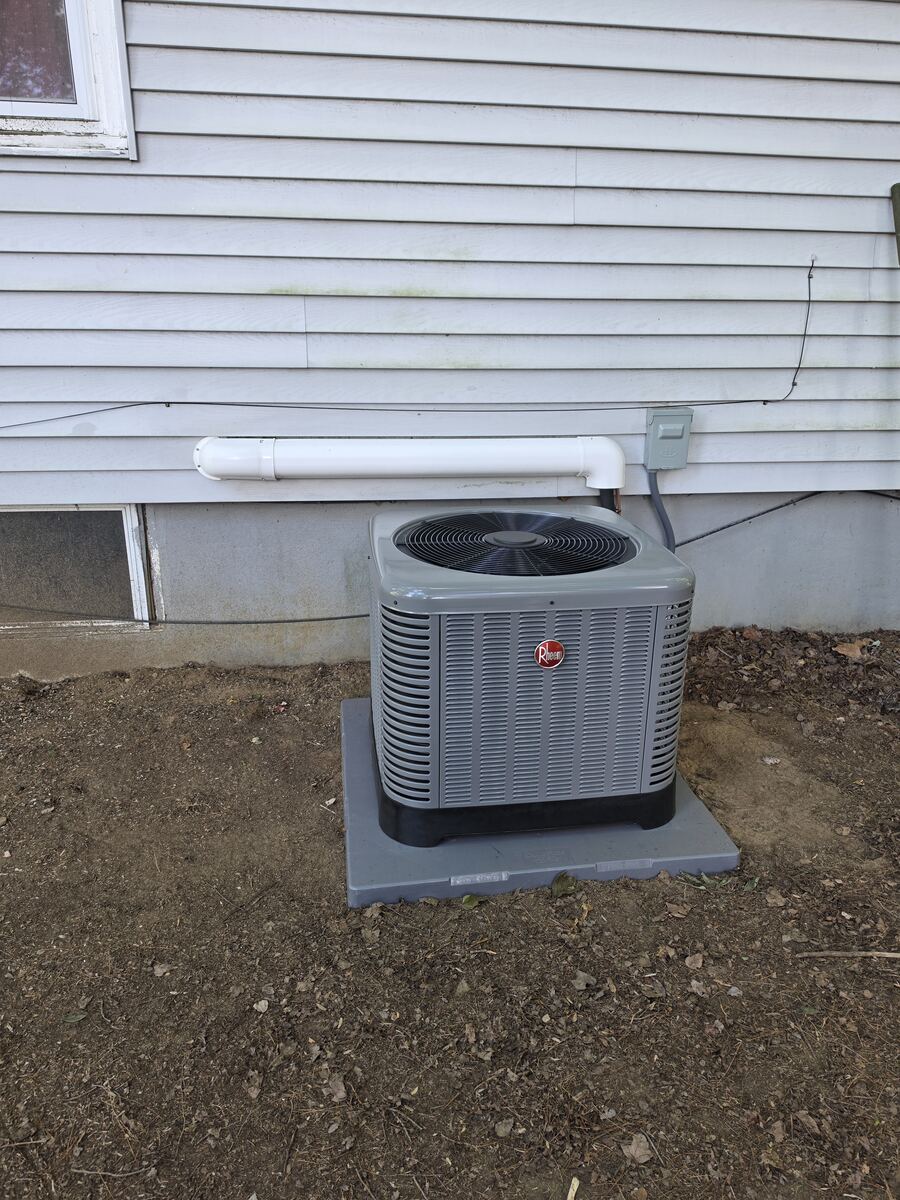 New outdoor AC condenser installed alongside a natural gas forced air retrofit