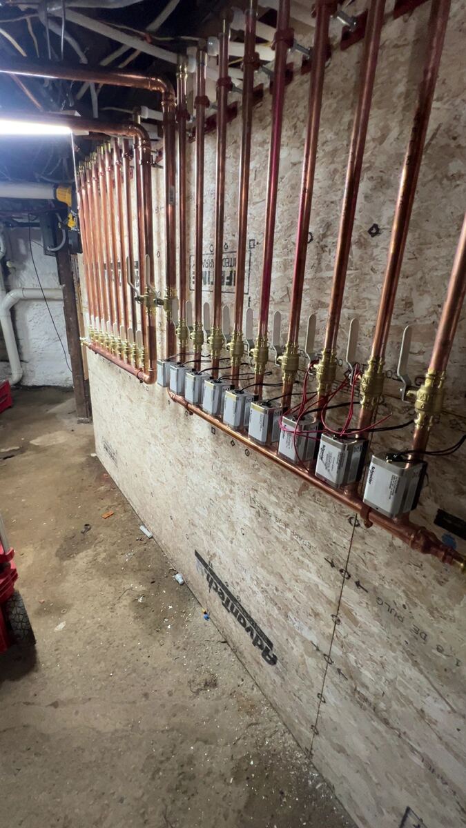 Copper supply and return manifold with zone valve actuators for a hot water boiler system