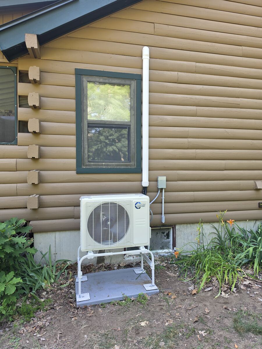 Ductless mini-split outdoor condenser installed on a raised stand