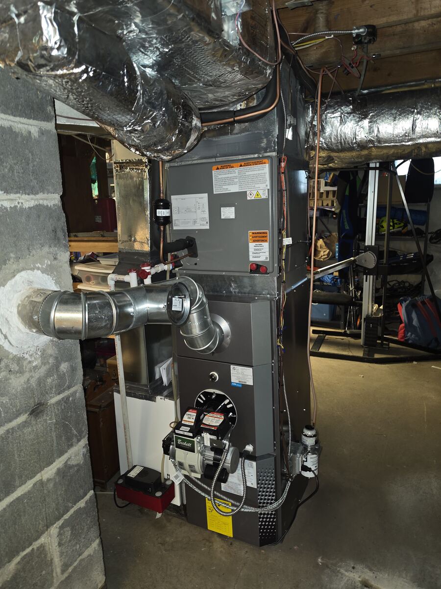 Oil-fired forced air furnace with new air filtration cabinet