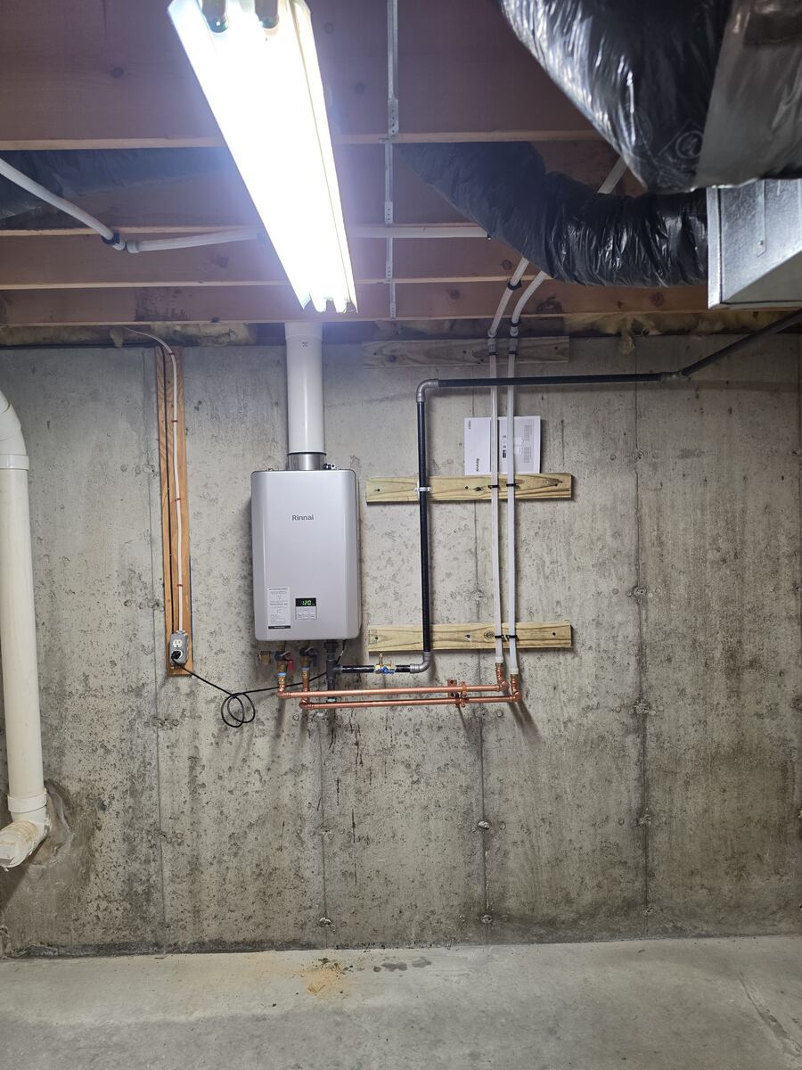 Rinnai LP gas tankless on-demand water heater installed on a basement wall